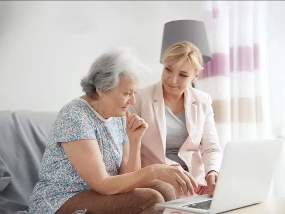 Two women looking at a laptop