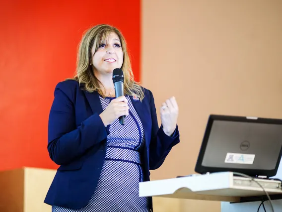 woman speaking in a blue dress