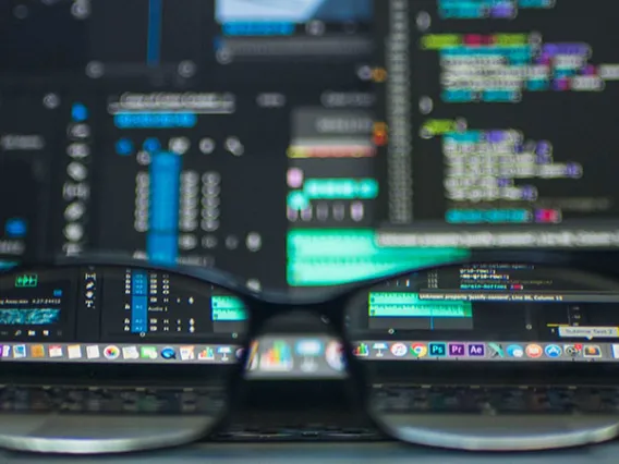 glasses in front of computer screen