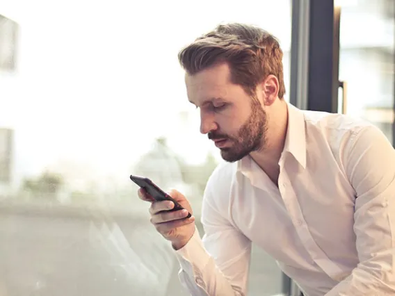 man looking at cell phone