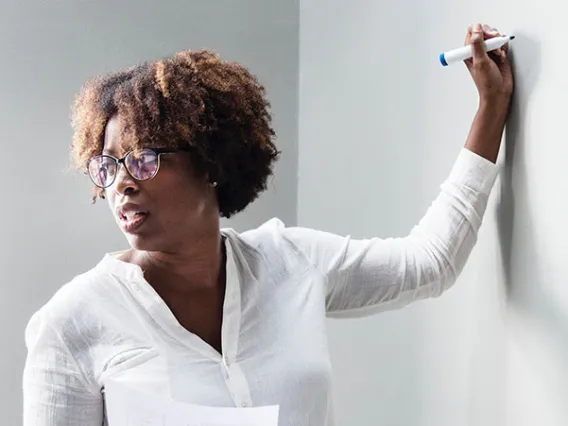 woman writing on whiteboard