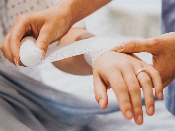 nurse bandaging woman's arm