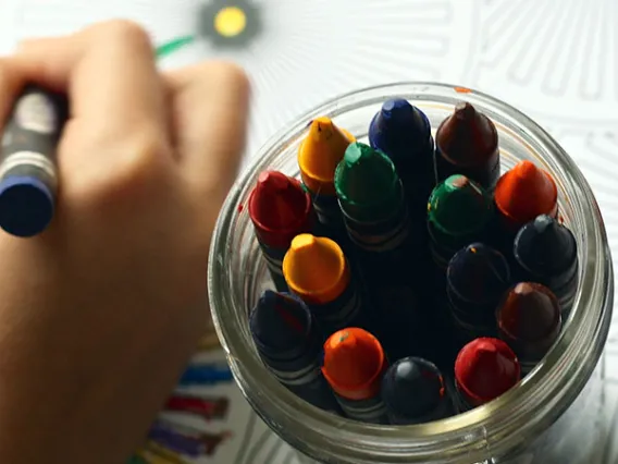 child's hand with crayons