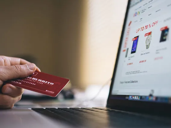 person with credit card and laptop