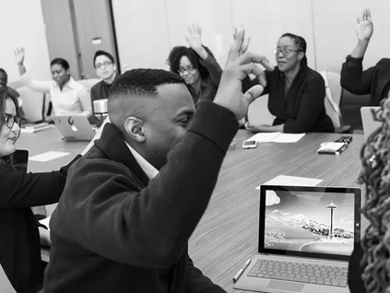 students raising hands