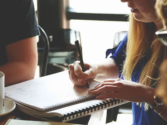 Woman writing in notebook