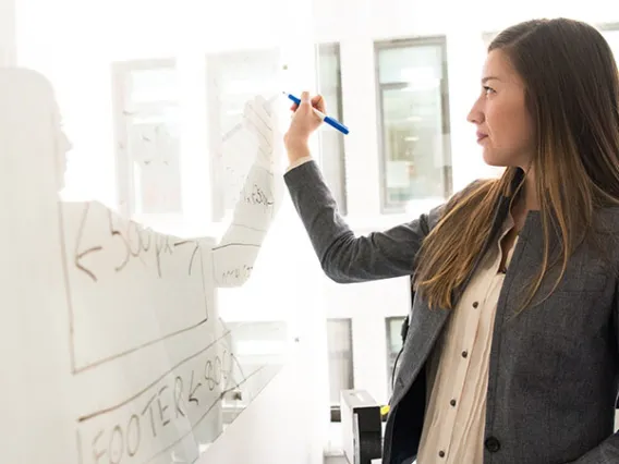 woman writing on whiteboard