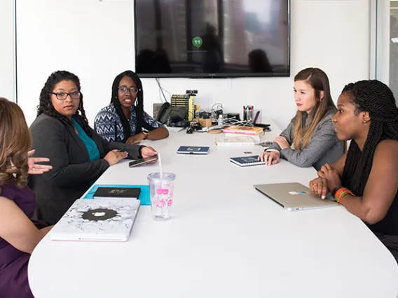 women talking around table