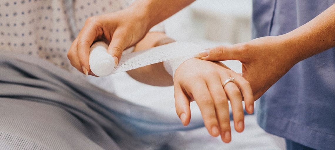 nurse bandaging woman's arm