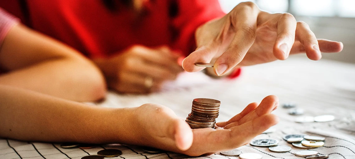 hand holding coins