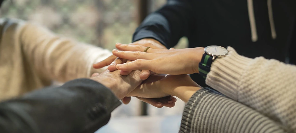 people putting hands together