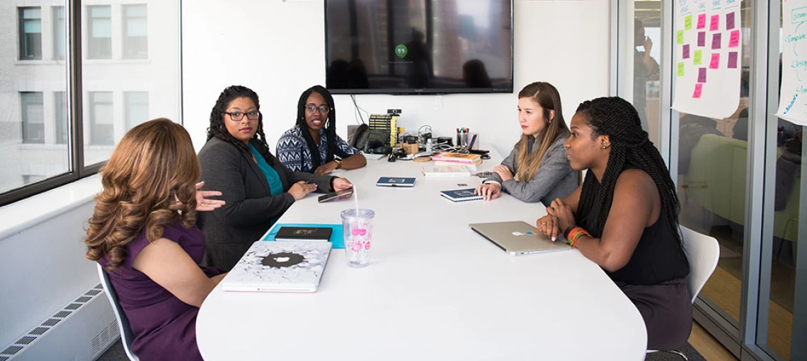 women talking around table