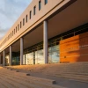 A photo of Eller College of Management with the sunset behind it