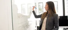 woman writing on whiteboard