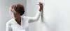 woman writing on whiteboard